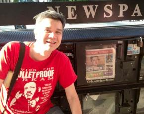 Xian Barrett, next to copies of the Chicago Sun Times reporting on his layoff from Gage Park High School